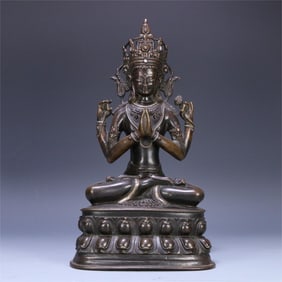 A four-armed statue of Guanyin with alloy copper and silver