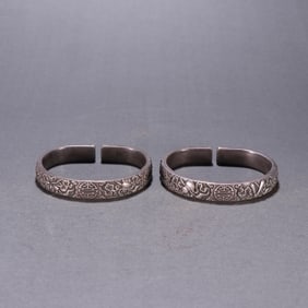 A pair of silver chisel eight treasure group longevity bracelets from the Qing Dynasty