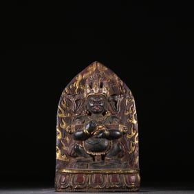 A black stone painted gold two-armed mahagala Buddha statue from the Qing Dynasty