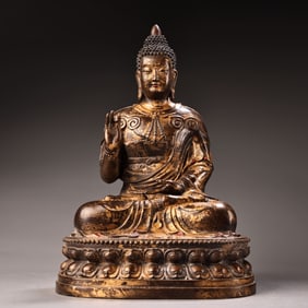 An all-bronze high-relief carved statue of Shakyamuni Buddha in gold