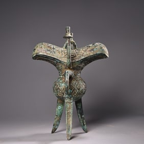A fine bronze three-legged wine glass