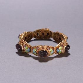 A Qing Dynasty silver-gilt crystal-encrusted roasted blue hand steak