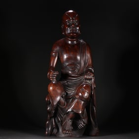 A Ming Dynasty Huanghuali carved Arhat statue