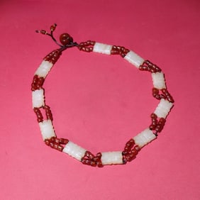 A piece of ripe pit white jade from the Shang and Zhou dynasties, and a necklace