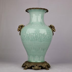 A delicate blue glazed bronze sheep's head amphora vase