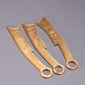 A beautiful set of copper-gilt knife coins