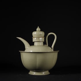 A secret color celadon carved figure wine jug from the Yue kiln of the Tang Dynasty