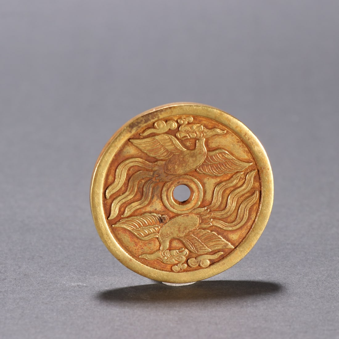 A fine copper-gilt phoenix coin (1 of 6)