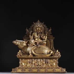 A bronze gilt elephant trunk red God of Wealth ornament from the Qing Dynasty