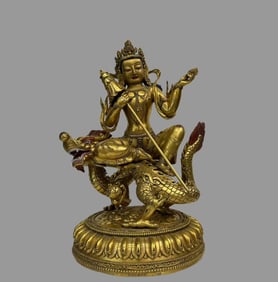 A beautiful copper gilt dragon riding Guanyin