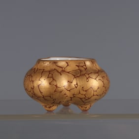 A piece of coral red glaze made in the Qianlong period of the Qing Dynasty with gold color melon and