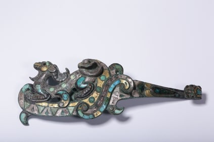 A bronze inlaid gold and silver inlaid turquoise beast with a hook from the Ming Dynasty