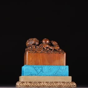 A Qing Dynasty agarwood carved dragon bite bead button seal