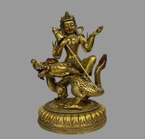 A beautiful copper gilt dragon riding Guanyin