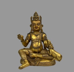 A beautiful copper gilt yellow god of wealth