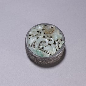 A sterling silver inlaid jadeite carved crane dance lotus pond lid box from the Qing Dynasty