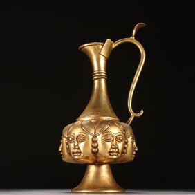 A Liao gold copper gilt relief engraved with a human face wine jug