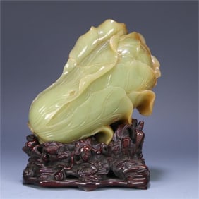 A Qing Dynasty Hetian topaz carved cabbage ornament was originally equipped with rosewood base jade