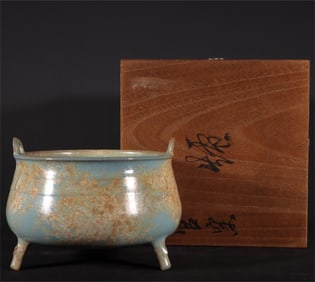 A celadon three-legged furnace of the official kiln of the Song Dynasty