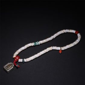 A fine pearl straight-cut rosary with a portable Buddha shrine