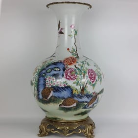 A beautiful pastel flower and bird inlaid with a copper-rimmed vase