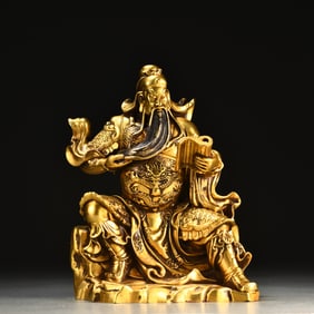 A seated statue of the God of Wealth in the Ming Dynasty with a fine cast copper tire gilt Guan Gong