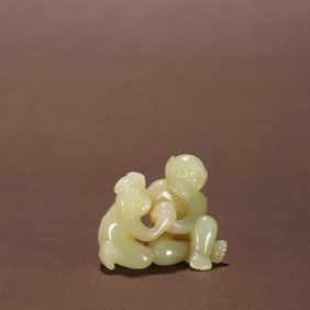 A Qing Dynasty Hetian topaz monkey birthday ornament