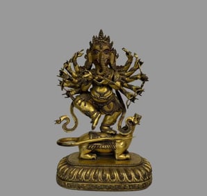 A beautiful copper-gilt elephant trunk god of wealth