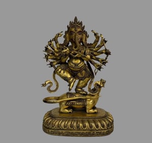 A beautiful copper-gilt elephant trunk god of wealth