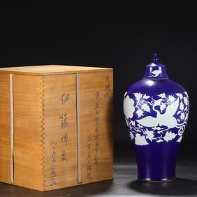 A large plum bottle with a lid with a clear blue glaze left blank and carved phoenix wearing a peony