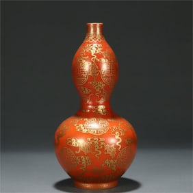 A red glazed gold auspicious cloud eight treasure gourd bottle from the Qing Dynasty