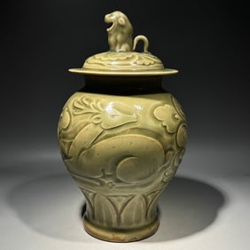 A blue-glazed carved deer-patterned lion button lid jar of the Yaozhou kiln in the Song Dynasty