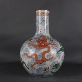 A pastel gold-painted auspicious cloud five-dragon Tianqiu bottle made in the Qianlong era of the
