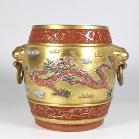 A Qing Dynasty Qianlong era enamel gold ground carved dragon lion ear incense burner