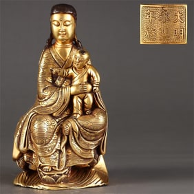 A seated statue of Guanyin in the Ming Dynasty with a gilded bronze tire