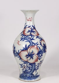 A blue and white glazed red longevity peach bat pattern olive bottle made in the Yongzheng period of