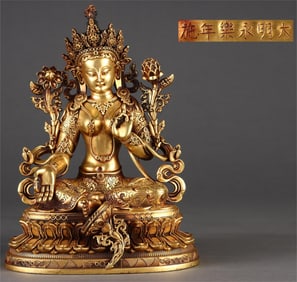 A seated statue of Tara in gilt green in the Ming Dynasty