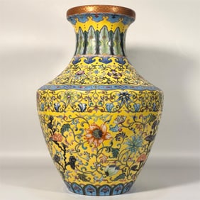 A Qing Dynasty Qianlong era enamel yellow ground entwined lotus flower pattern appreciation vase