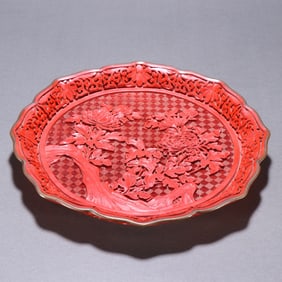 A red carved plate of the Qing Dynasty