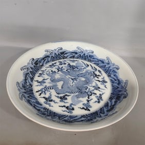 A large plate with a blue and white dragon pattern in the Ming Dynasty