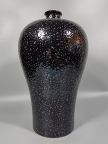 A Qing Dynasty eggplant skin purple glaze plum bottle