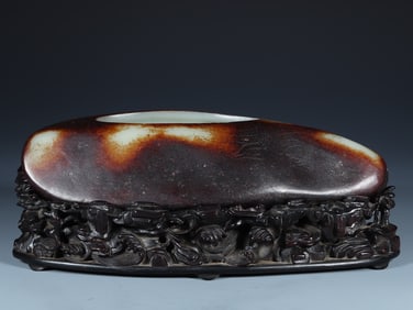A washed ornament of Hetian jade raw stone seed cow pattern in the Qing Dynasty