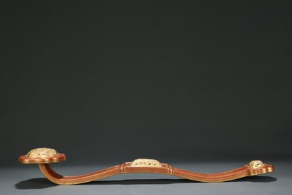 A red glaze gold-painted hollow ruyi from the Qing Dynasty