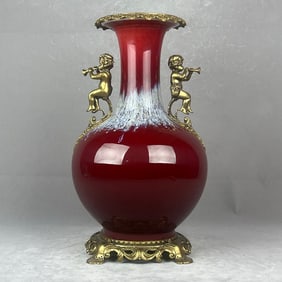 A beautiful kiln-glazed bronze angel playing amphora vase