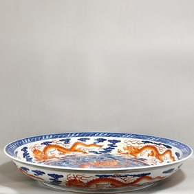 A blue and white alum red seawater dragon pattern plate made in the Qianlong period of the Qing