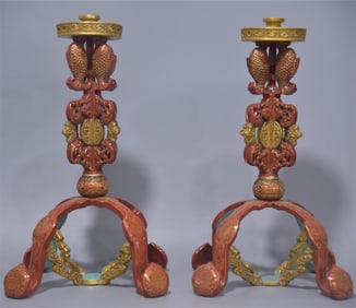 A pair of Qing Dynasty red gilded candlesticks
