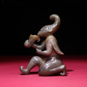 A small ornament of the Han Dynasty feathered man offering wine