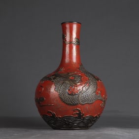 A bronze coral red carved celestial ball vase made in the Qianlong era of the Qing Dynasty