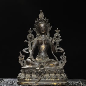 A bronze and gilded green Tara Buddha statue