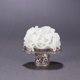 A Qing Dynasty silver-inlaid Hetian jade carved flower and bird pattern carving